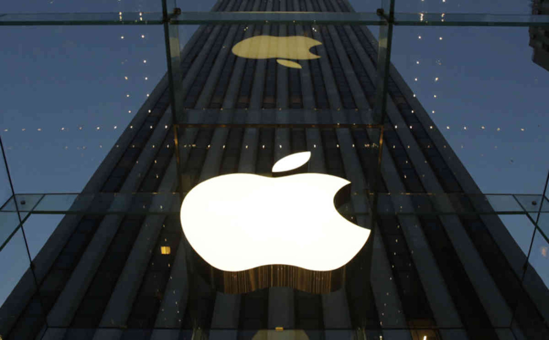 The Apple logo is illuminated in the entrance to the Fifth Avenue Apple store, Wednesday, Nov. 20, 2013 in New York. (AP Photo/Mark Lennihan)